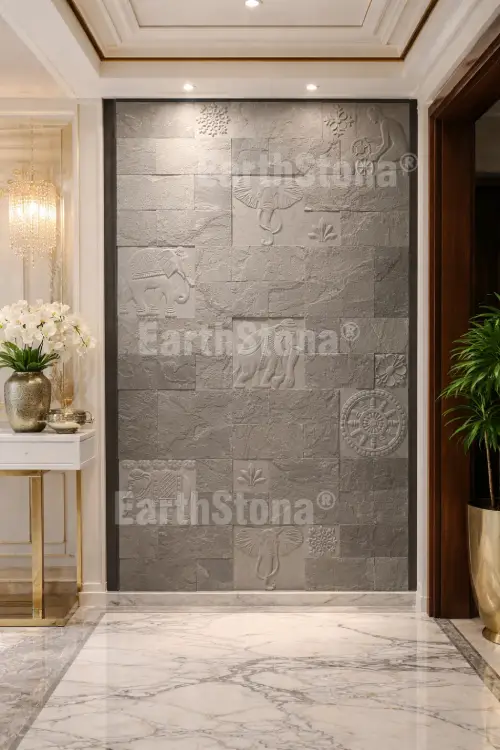 Hand carved elephant motif natural stone wall cladding panel installed on luxury bungalow entrance foyer wall